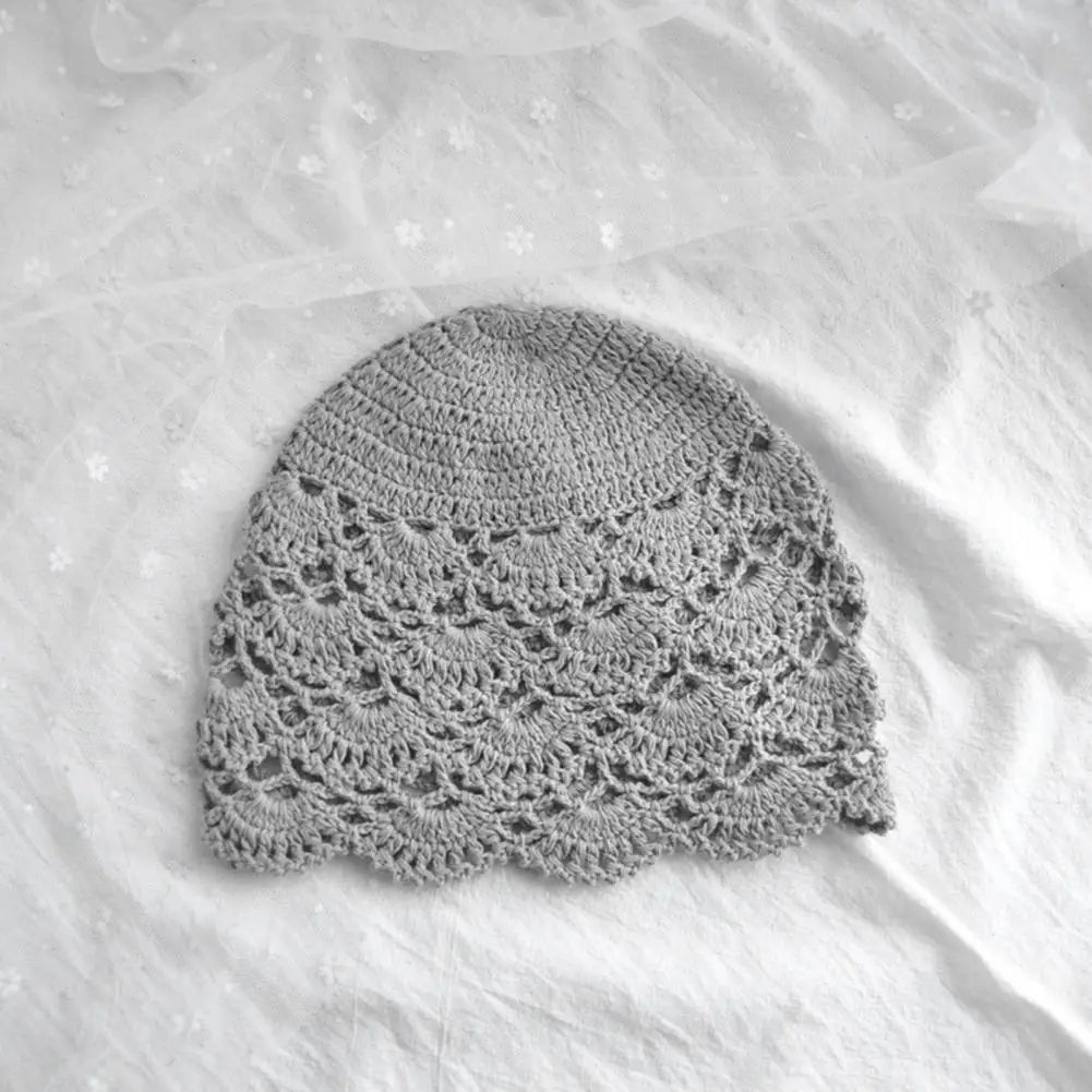 Grey women's crochet beanie featuring a delicate, hollow scalloped lace pattern.