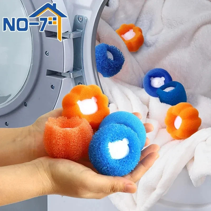 Hands holding orange and blue round laundry sponge hair catchers in front of a washing machine.