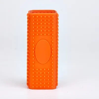 Bright orange, rectangular silicone toothbrush cover with textured, pimpled surface and central oval detail.
