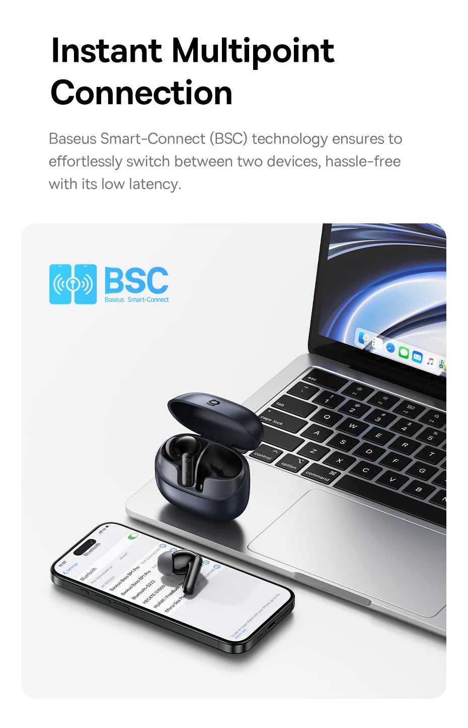 Dark grey wireless earbuds in a charging case, placed on a laptop next to a smartphone.