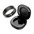 Glossy black smart health ring with underside sensors, shown with its matching open charging case.