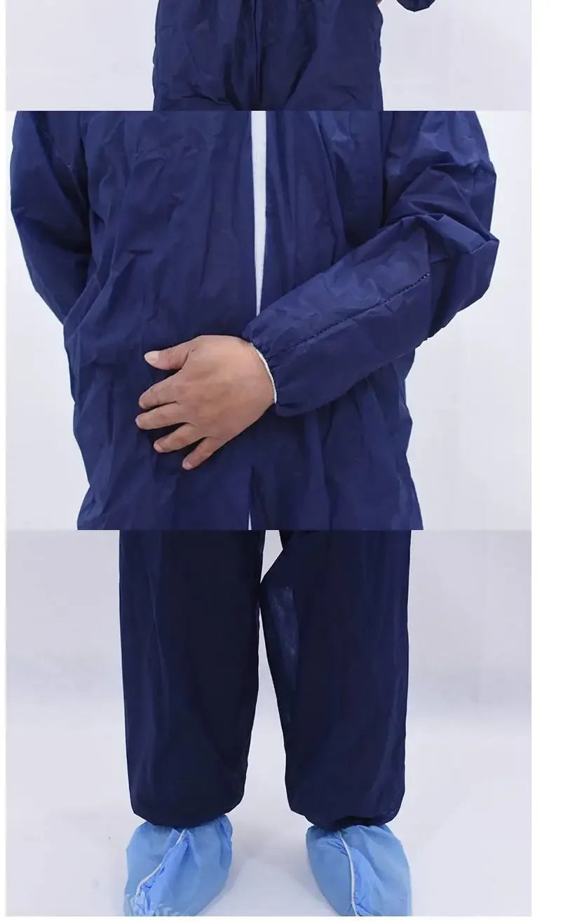 Dark blue, long-sleeved synthetic protective coverall with elastic cuffs worn with light blue shoe covers.
