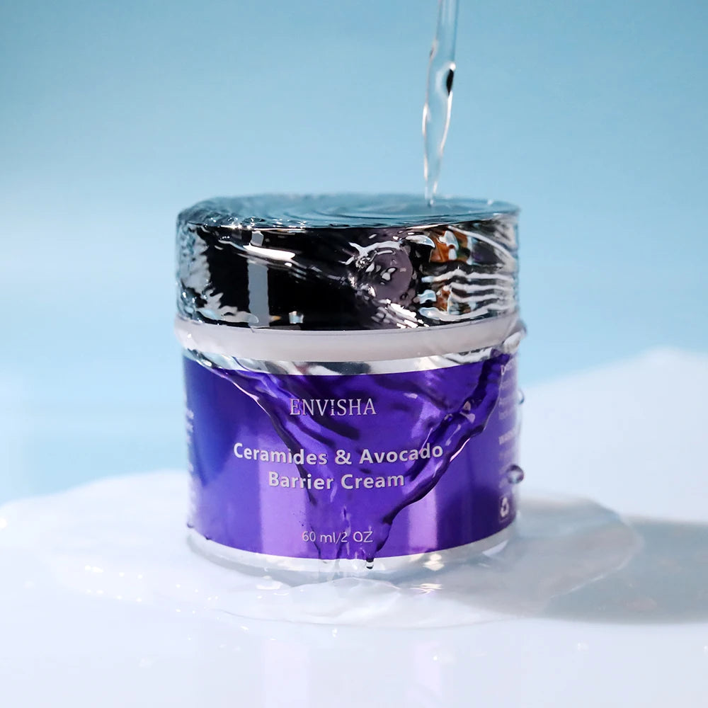 Purple 60ml jar of Ceramides & Avocado barrier cream with a shiny metallic lid, shown under a refreshing water flow.