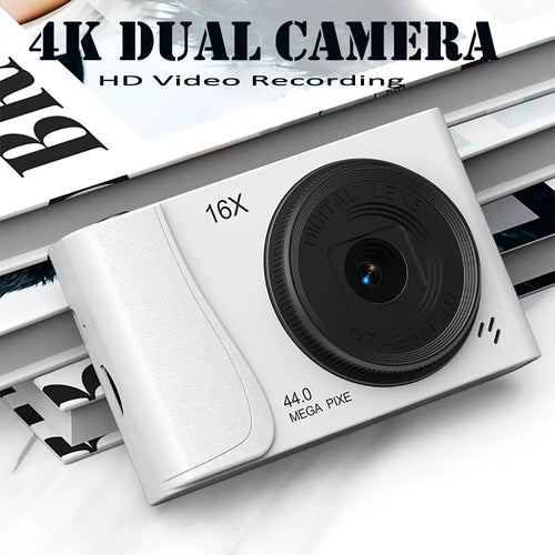 White plastic 4K digital camera with a black lens, 16x zoom, and 44-megapixel sensor.