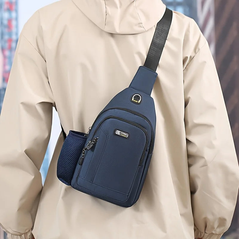 Blue Oxford fabric crossbody chest bag with an adjustable strap, zip pocket, and side mesh water bottle holder.