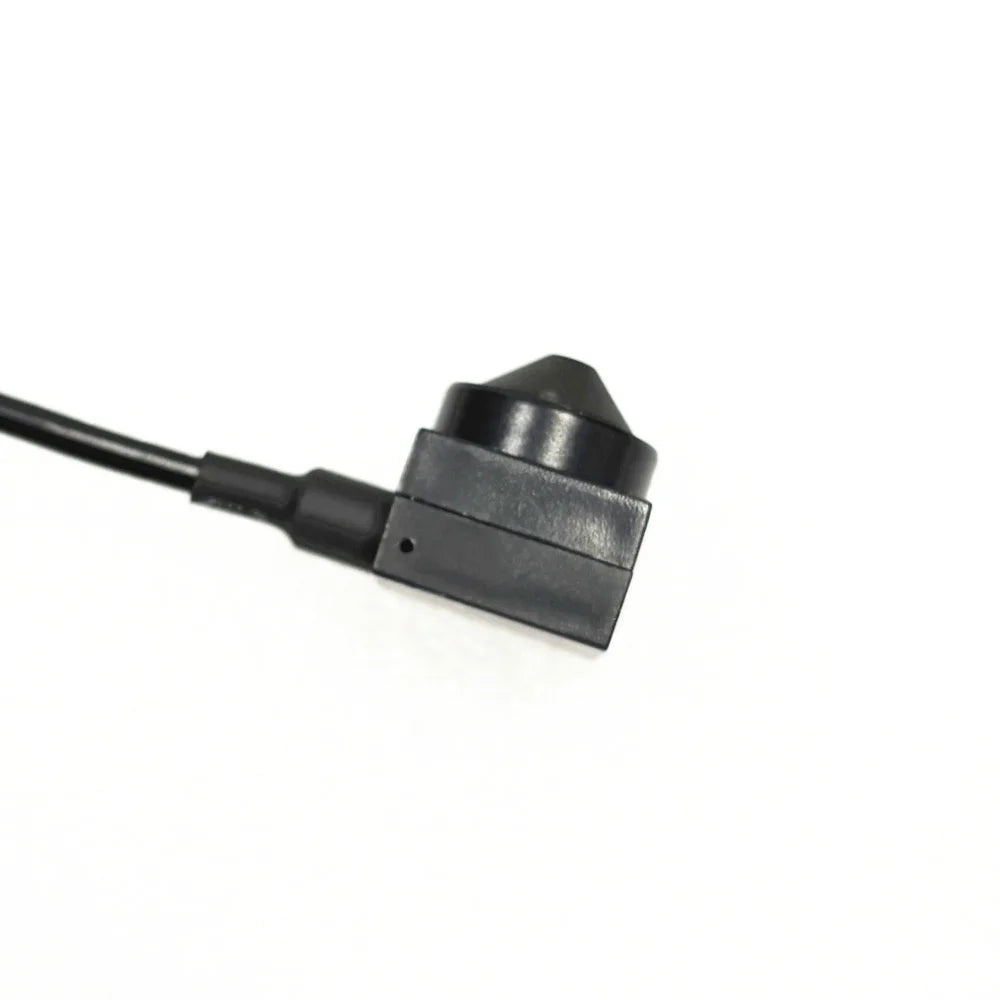 Small black plastic wired surveillance camera with a cone-shaped lens, isolated on a white background.