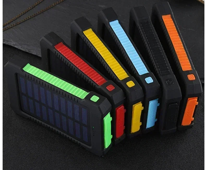 Six rugged, portable solar power banks in black with colourful edge accents, featuring built-in solar panels.