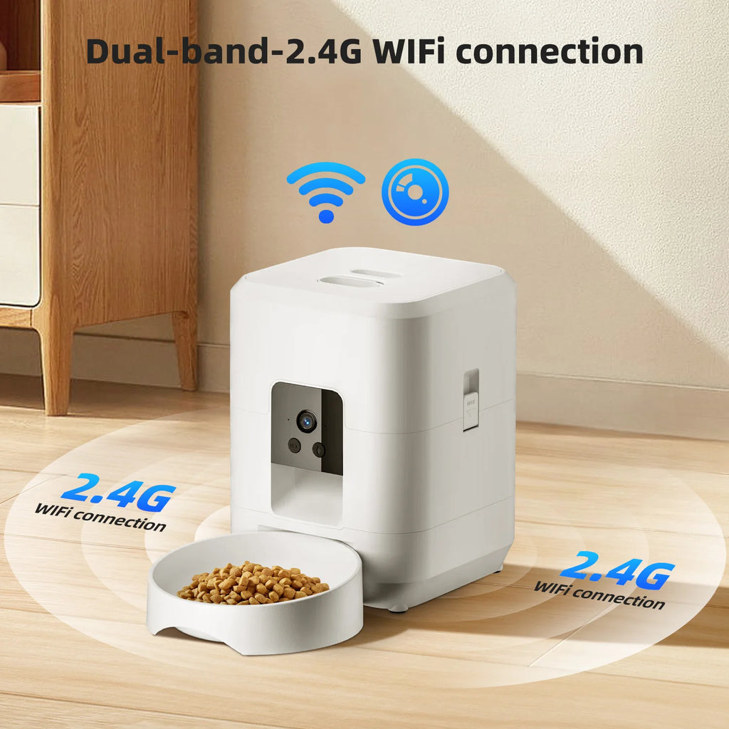 White, minimalist smart pet feeder with an integrated camera and attached feeding bowl on a wooden floor.