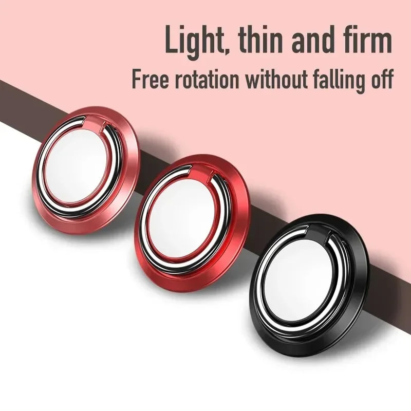 Three round, thin phone ring holders in pink, red, and black with metallic silver ring attachments.