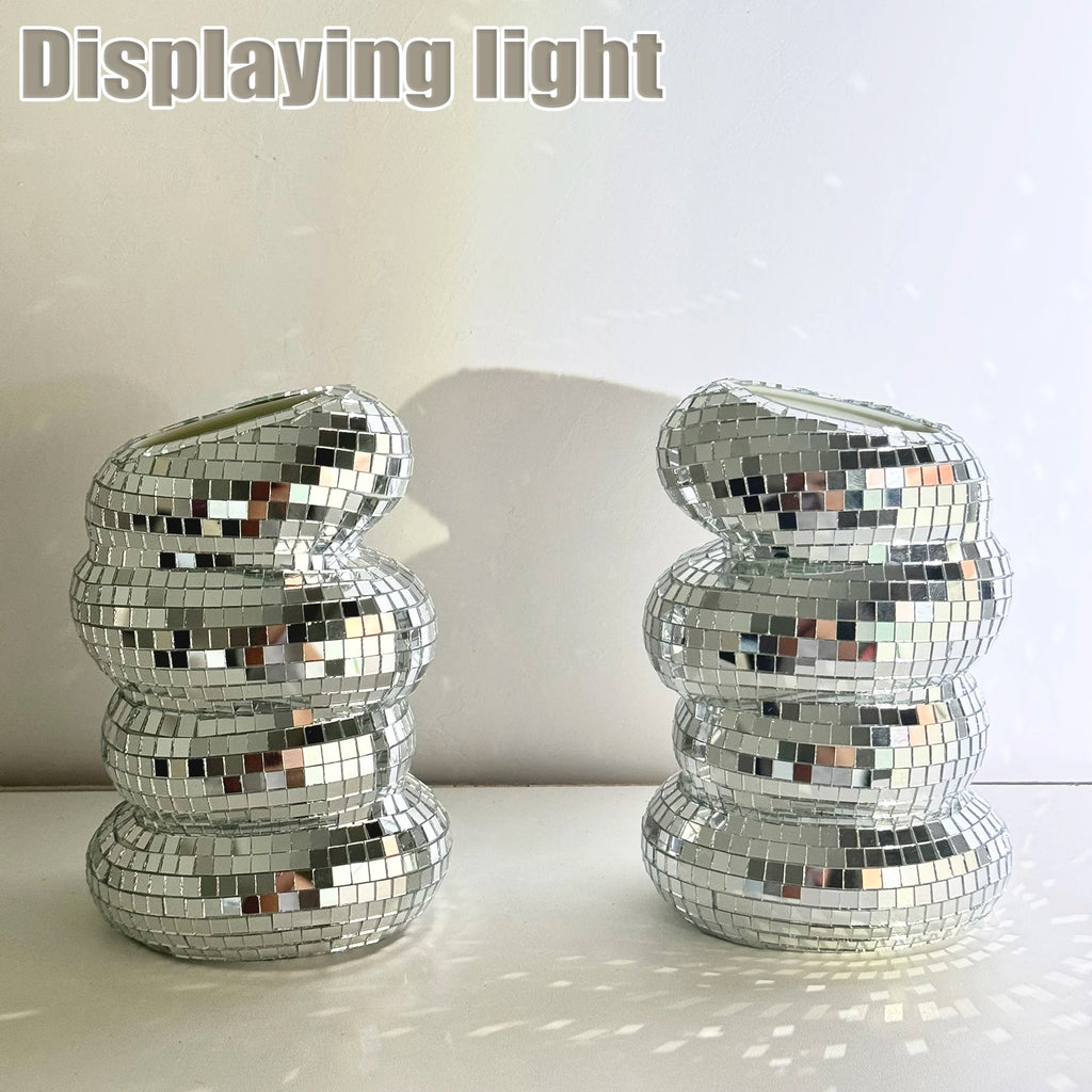 Two stacked, sculptural flower vases covered in reflective silver mirrored tiles, creating a shimmering disco ball effect.