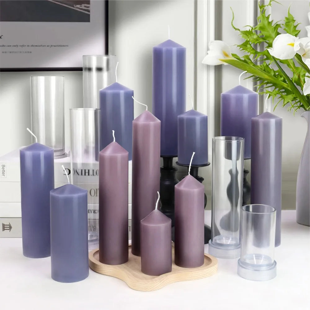 Various purple pillar candles and clear plastic cylindrical molds in multiple sizes.