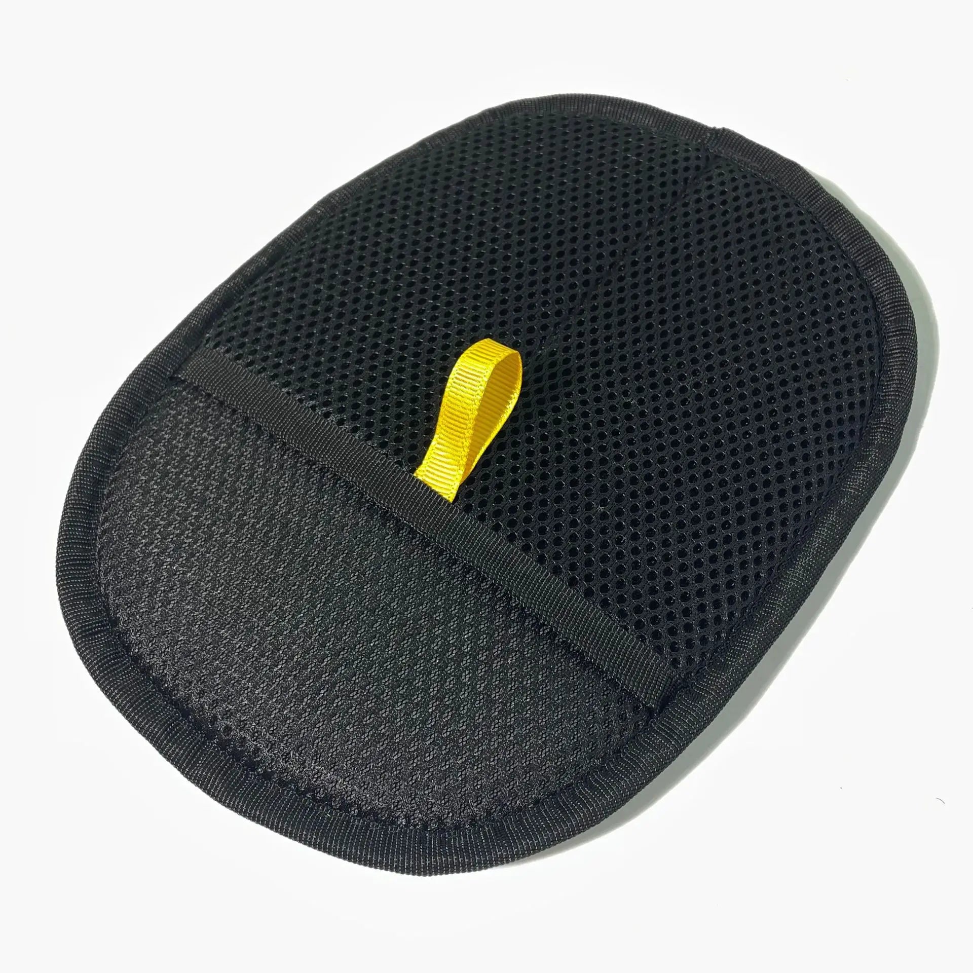 Oval black mesh exfoliating mitt with a yellow fabric hanging loop, isolated on a white background.