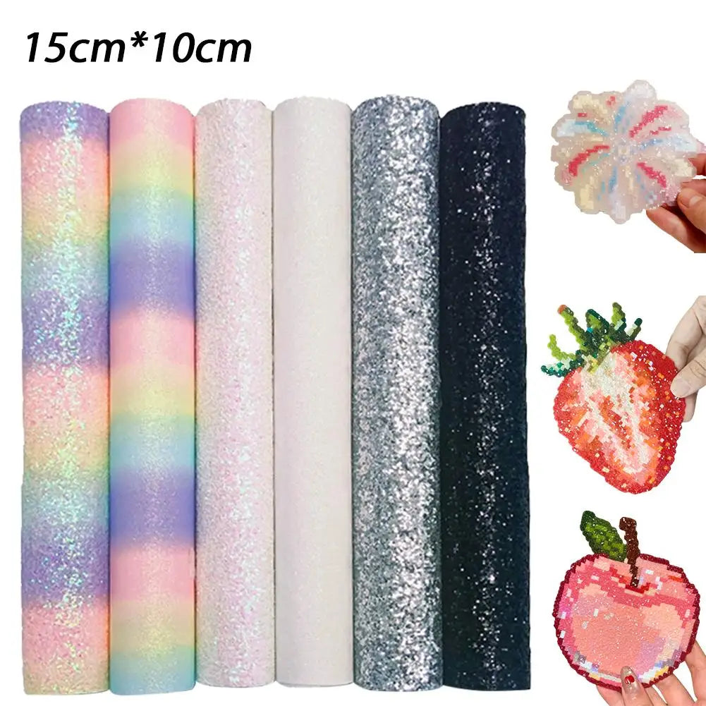 Six rolls of 15x10cm assorted glitter and rainbow craft fabric sheets, shown with example fruit-shaped cutouts.