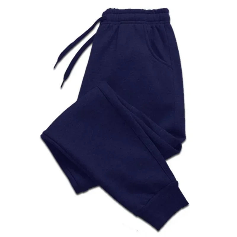 Navy blue joggers with an elasticated drawstring waistband, side pockets, and cuffed ankles.