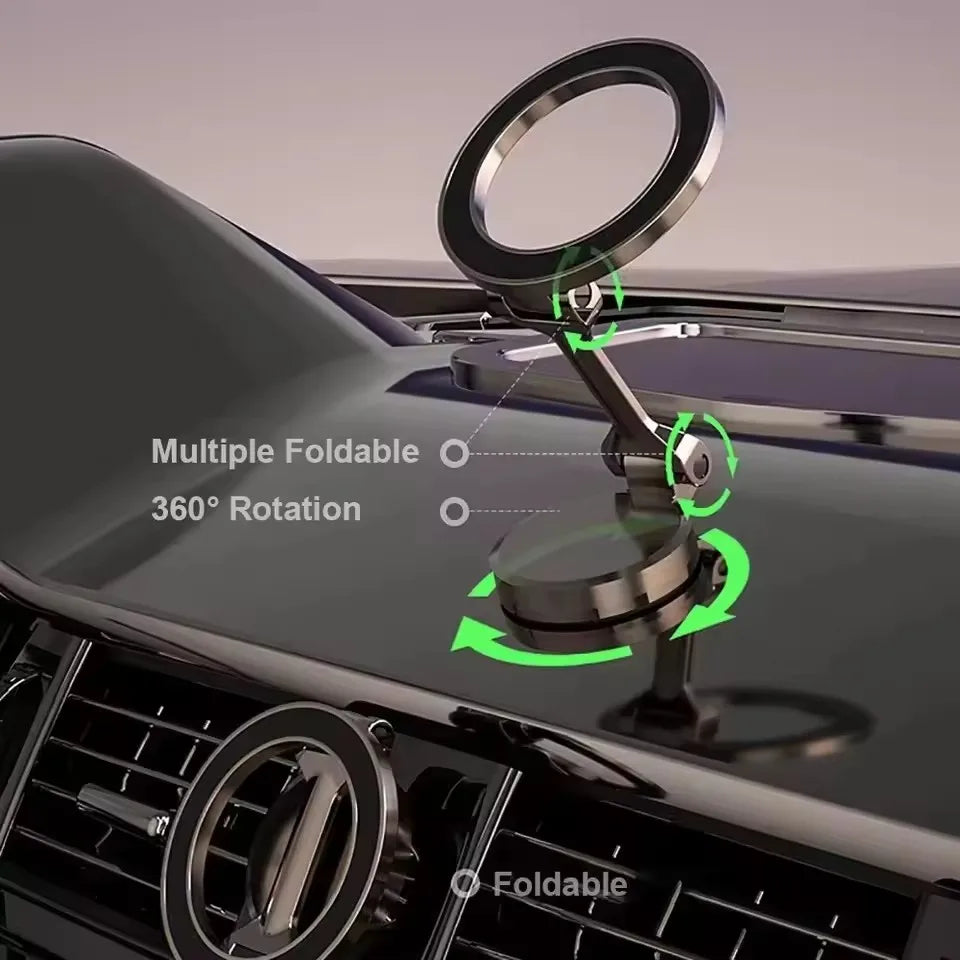 Dark grey metallic car phone holder, foldable design with 360-degree rotation, mounted on a vehicle dashboard.