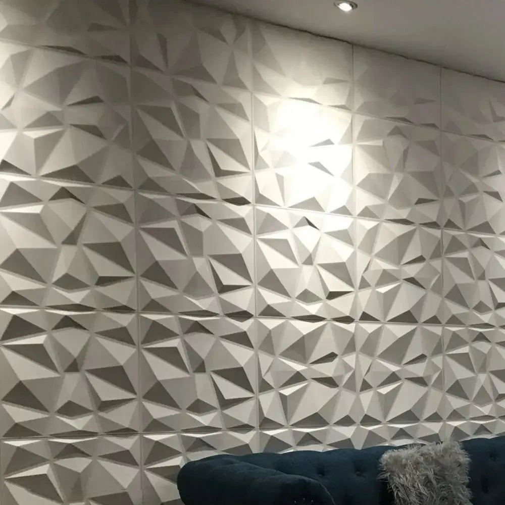 Modern white 3D wall tiles with a geometric diamond pattern, creating a textured, decorative effect in a living space.