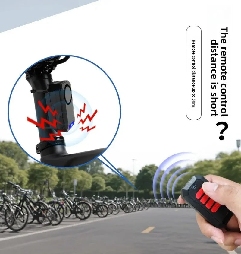 Black plastic bike alarm mounted on a seat post, controlled by a small remote with red buttons.