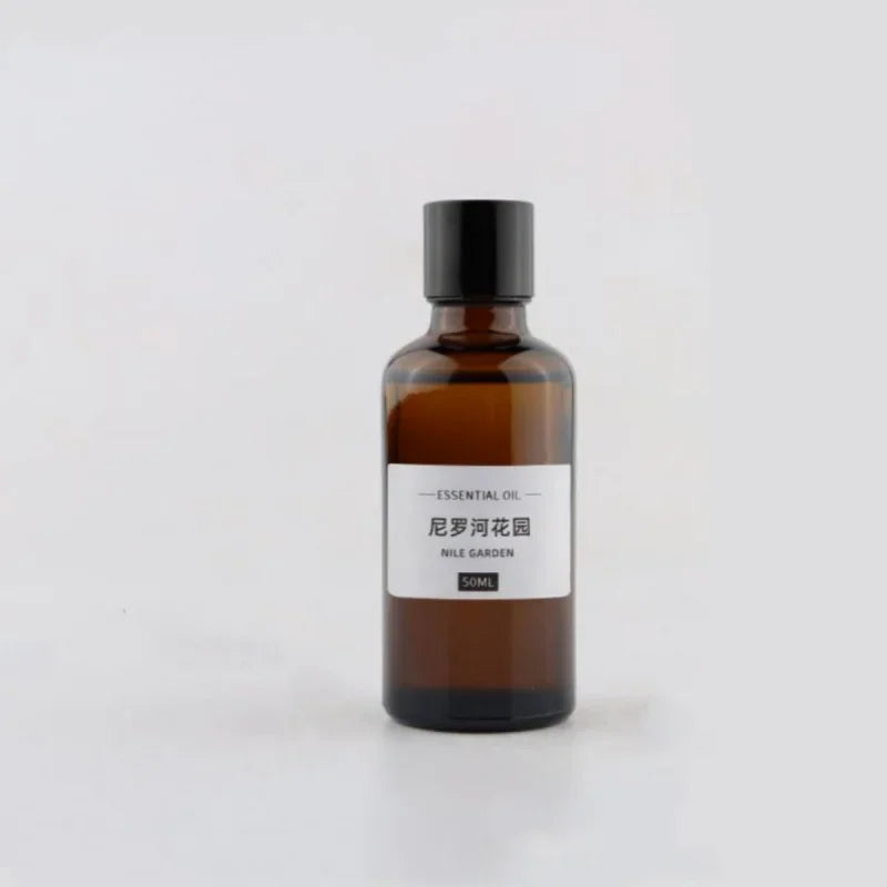 50ml amber glass bottle of Nile Garden essential oil with a black screw cap and minimalist white label.