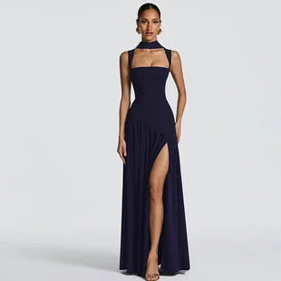 Navy blue maxi dress with a halter neckline, square bodice, and a high thigh-high slit on a model.