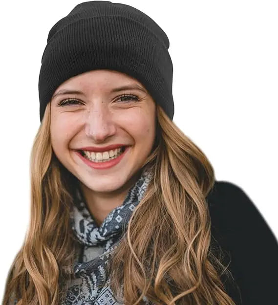 A woman wearing a black ribbed, satin-lined knitted winter beanie hat.