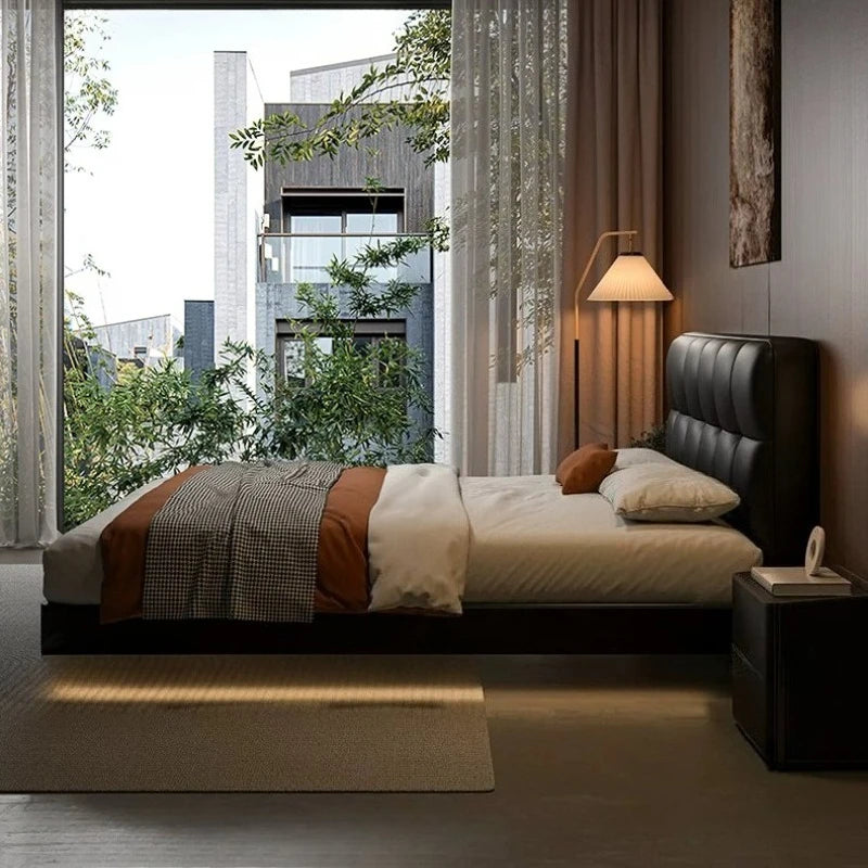 A luxury, modern, black leather floating double bed with a tufted headboard in a stylish, well-lit bedroom.