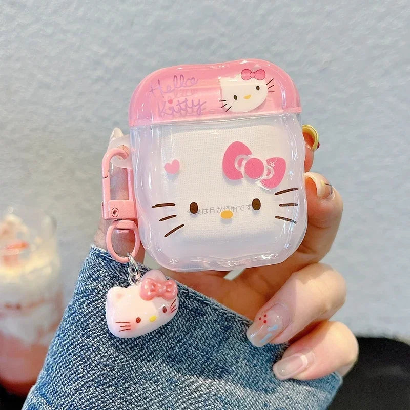 Pink Hello Kitty AirPods case in clear plastic with matching character charm and keyring clip.