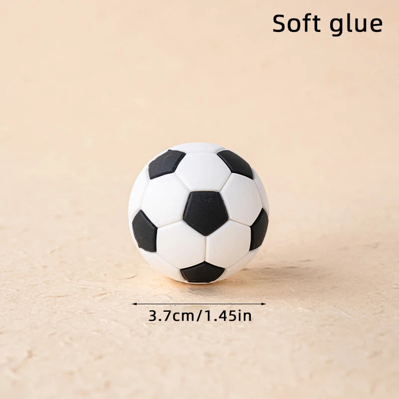 Small black and white football made of soft, flexible material, measuring 3.7cm in diameter.