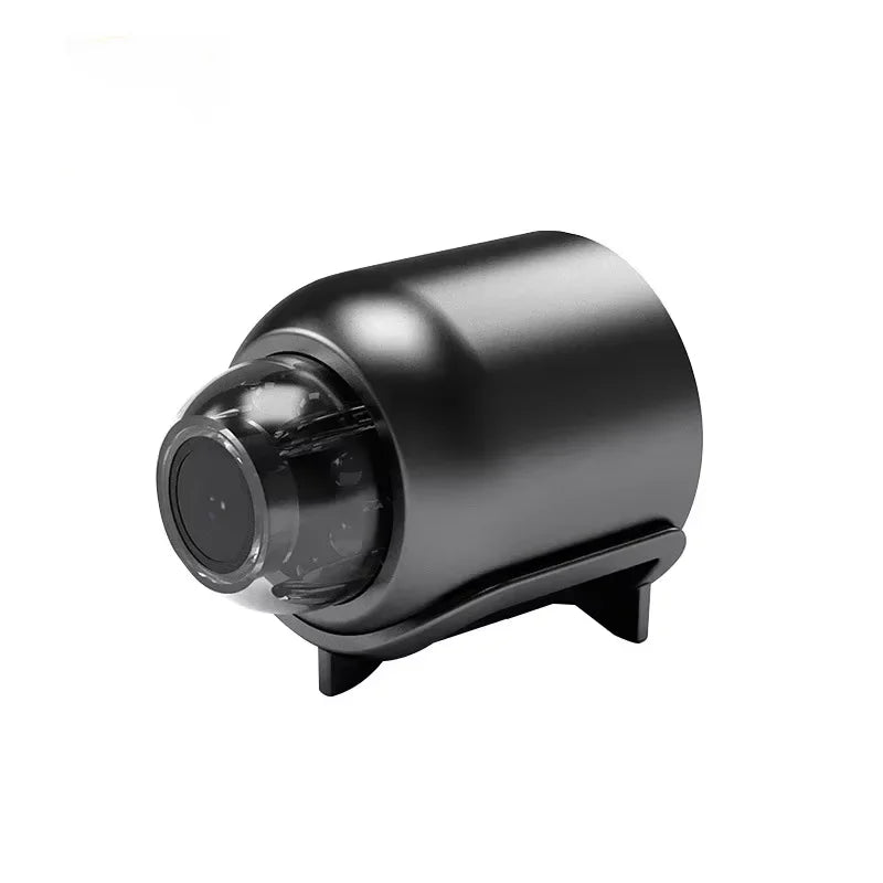 Black plastic cylindrical wireless security camera with a transparent front lens cover and mounting base.
