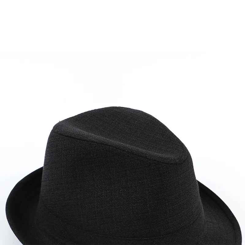 Classic black fedora hat with a subtle textured pattern, featuring a traditional pinched crown and wide brim.