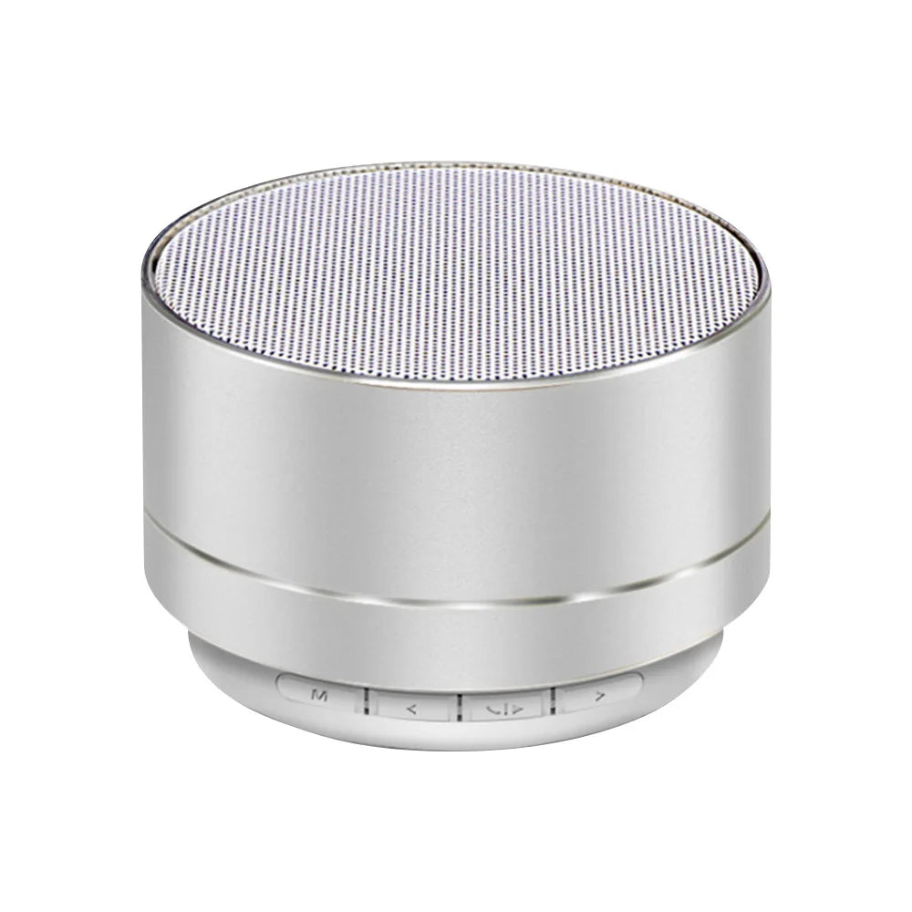 Compact silver aluminium Bluetooth speaker with a top mesh grille and control buttons along the base.