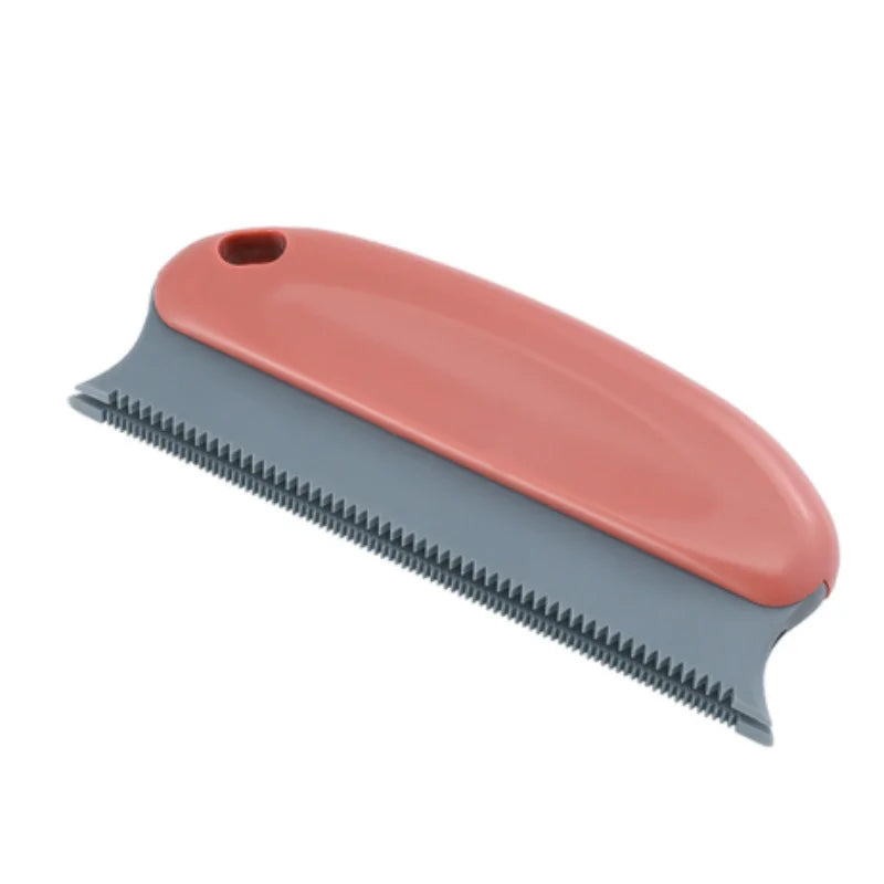 A terracotta-coloured pet fur remover tool with a grey serrated edge and a small hanging hole.