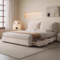 Modern cream storage bed with a plush, padded headboard and integrated under-bed drawers in a minimalist bedroom.
