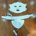 White silicone face and neck beauty masks with geometric gold patterns and attached white USB cables on wood.