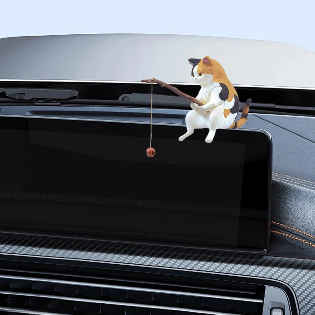 A cute calico cat ornament sitting and holding a fishing rod with a dangling red bobber.