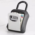 Black and white metal padlock-style key storage box with a four-digit combination lock, holding a bank card.