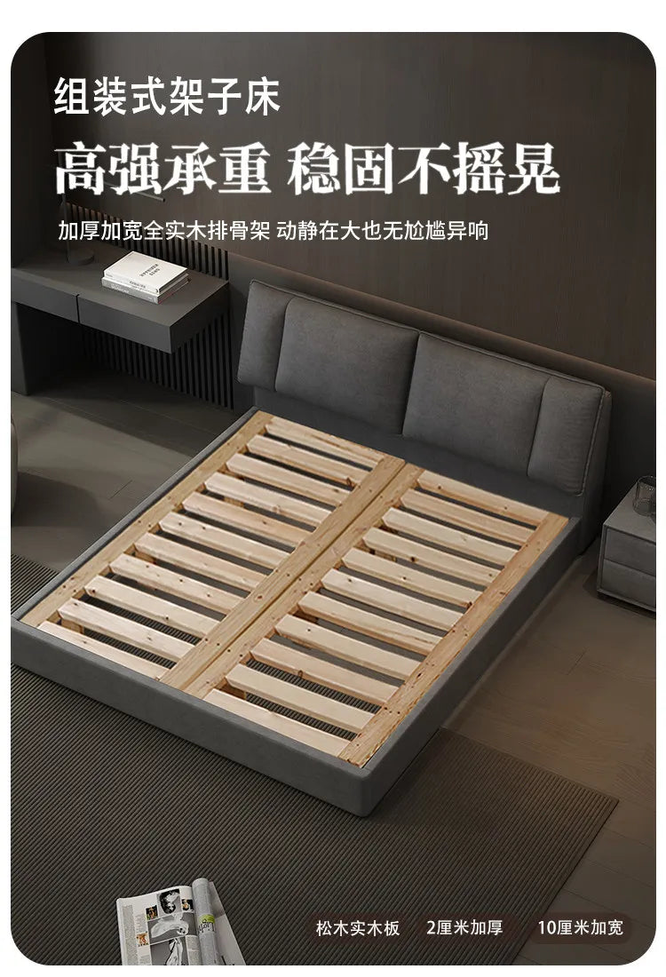 Modern grey upholstered double bed featuring a sturdy wooden slatted base in a contemporary bedroom setting.
