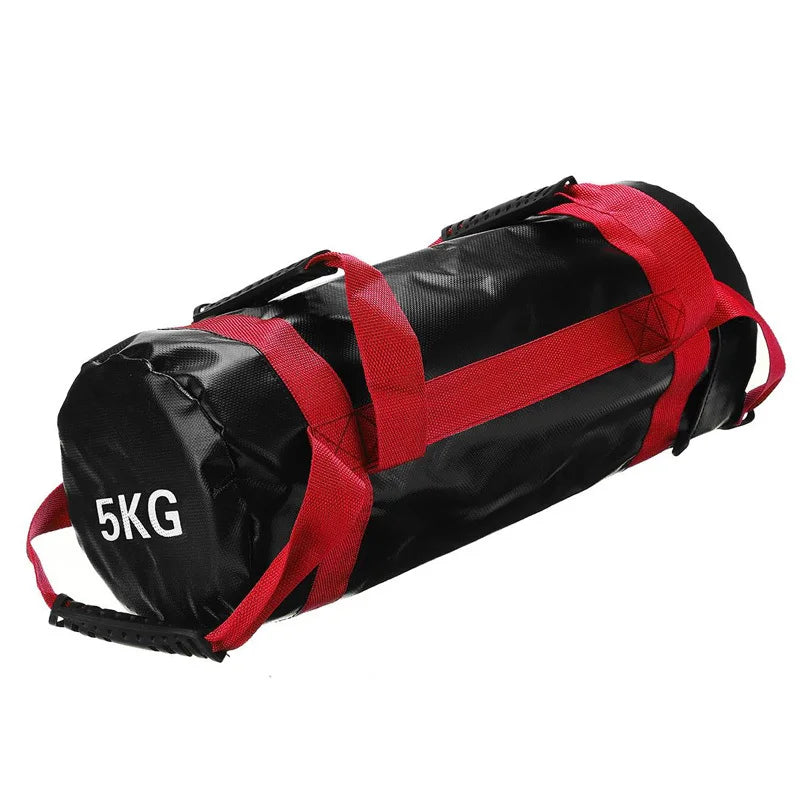 Black cylindrical fitness sandbag with red straps and handles, featuring "5KG" printed in white on the end.