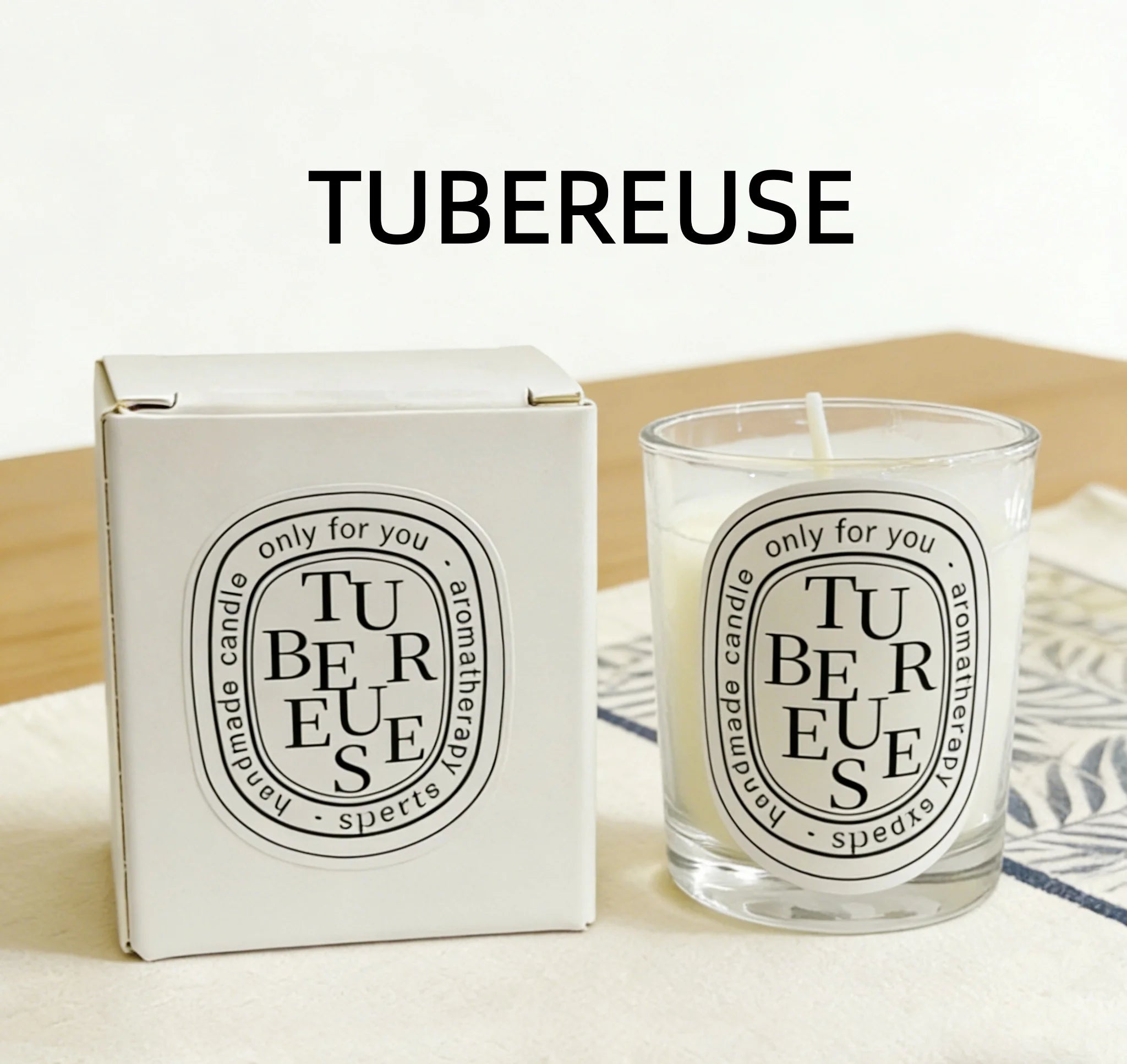 Tubereuse scented candle in a clear glass jar with matching white gift box, featuring a minimalist oval label.
