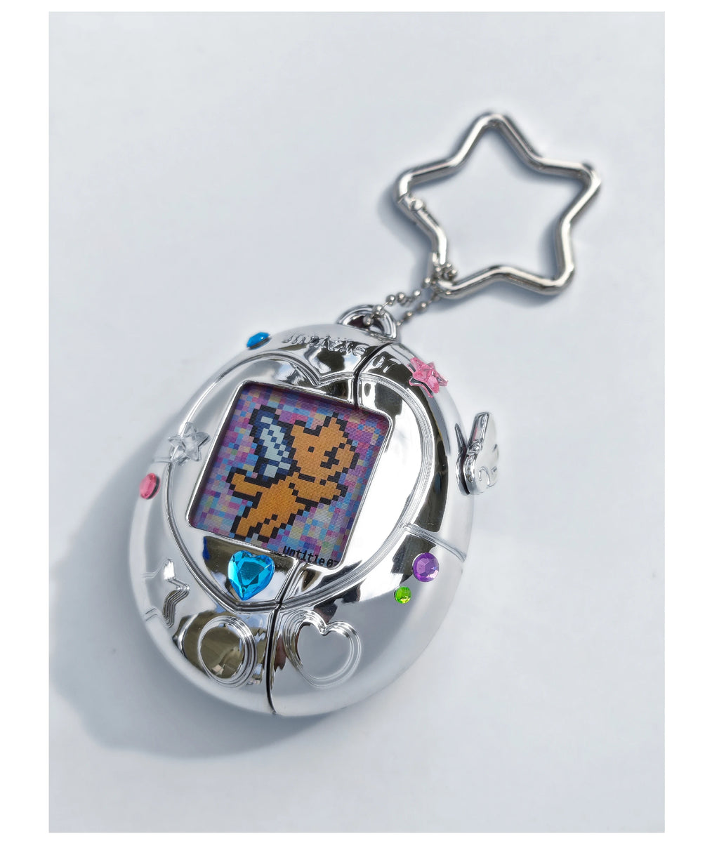 Silver metallic Tamagotchi-style AirPods case with star keyring, gem accents, and pixel art screen design.