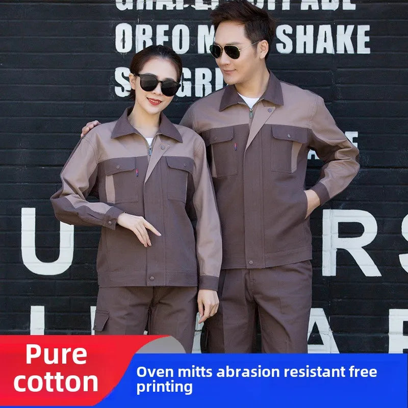 Man and woman wearing brown and tan cotton long-sleeve work jackets with button-flap chest pockets and zip fronts.