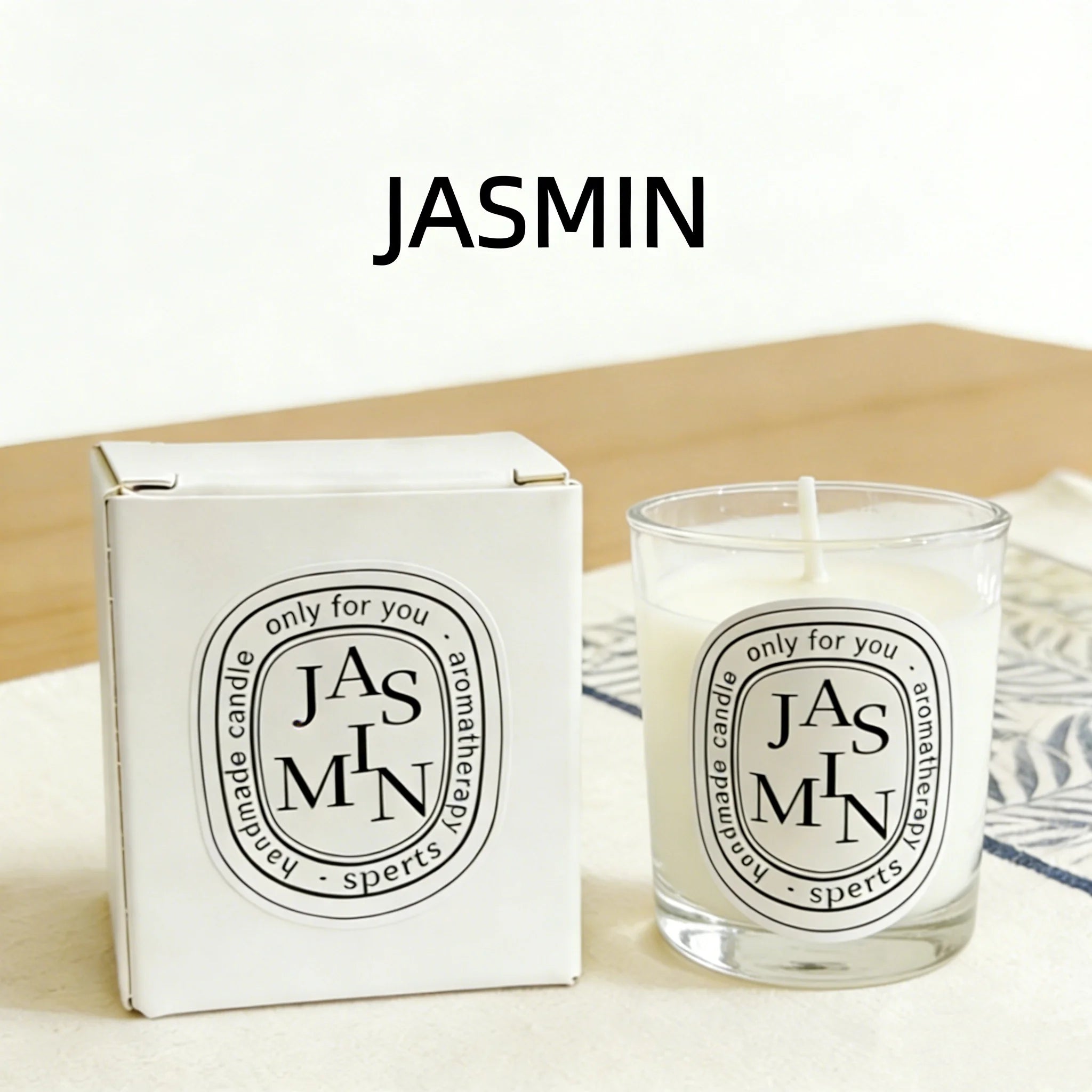 Handmade jasmine-scented aromatherapy candle in a clear glass jar with a matching white gift box.