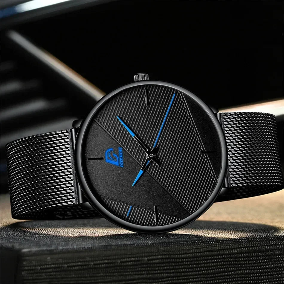 Minimalist men's ultra-thin quartz watch with a black mesh strap, textured black dial, and bright blue hands.