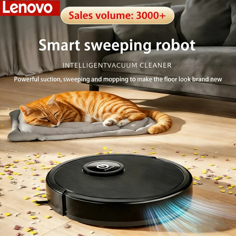 A black Lenovo robotic vacuum cleaner cleans a wooden floor near a sleeping orange cat.