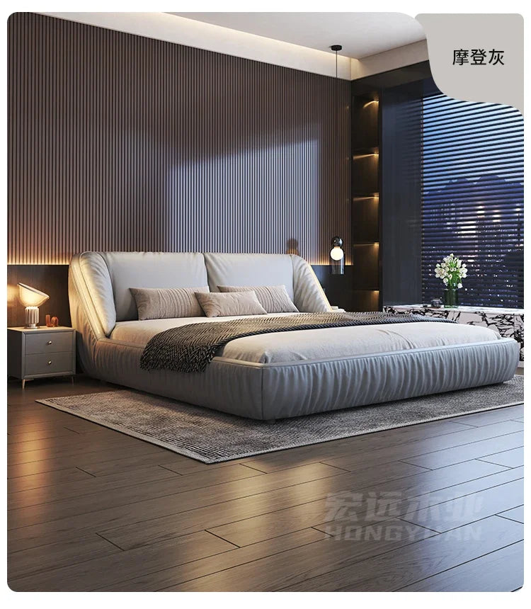 Modern king-size bed frame in soft grey upholstery with a luxurious, curved low-profile design.