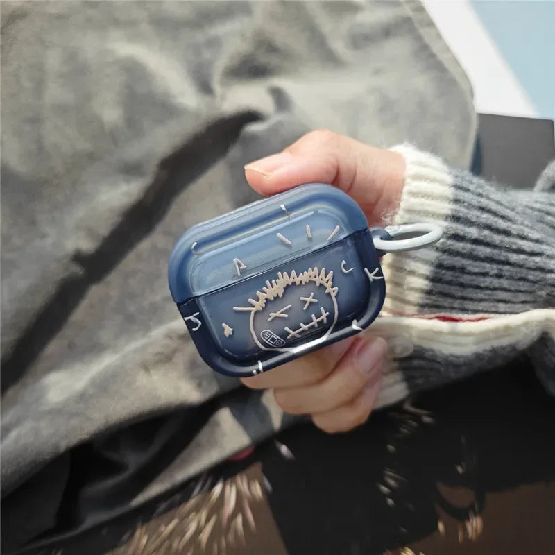 Translucent navy blue silicone case for AirPods Pro, featuring a white stitched face design and side carabiner clip.