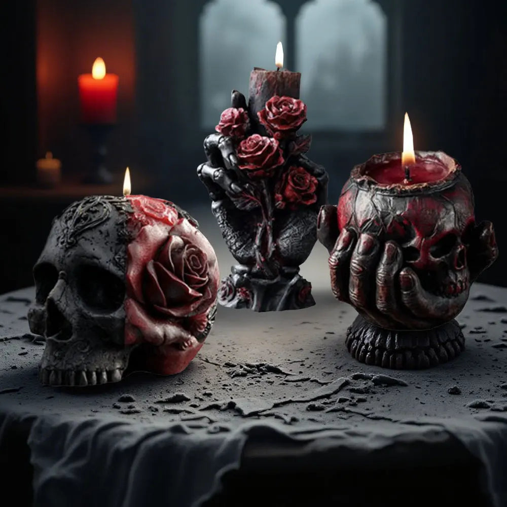 Gothic black and red candles featuring sculpted skulls, bone hands, and rose reliefs on a dark surface.