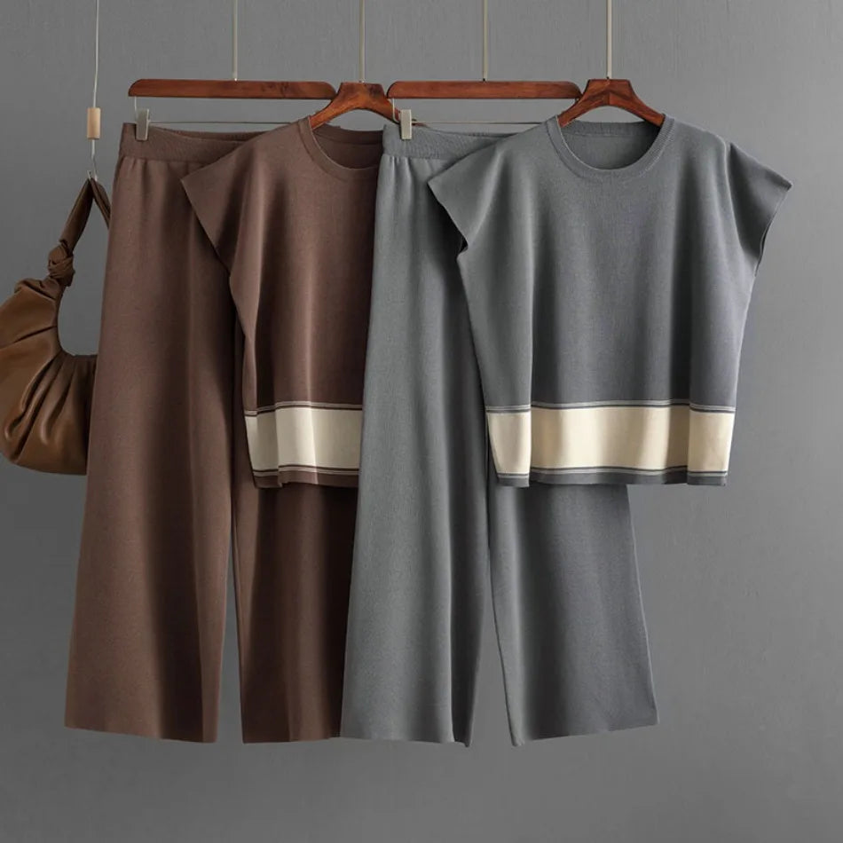 Two knit lounge sets in brown and grey, featuring wide-leg trousers and short-sleeved tops with a striped hem detail.