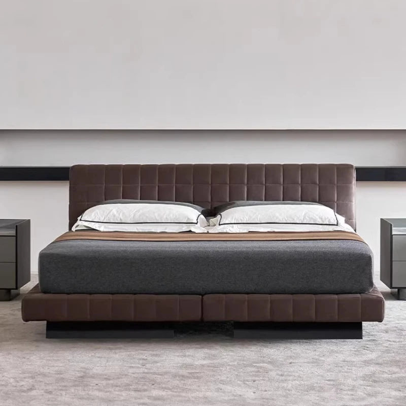 Modern Nordic brown upholstered bed frame with a panelled headboard and base, styled with grey and white bedding.