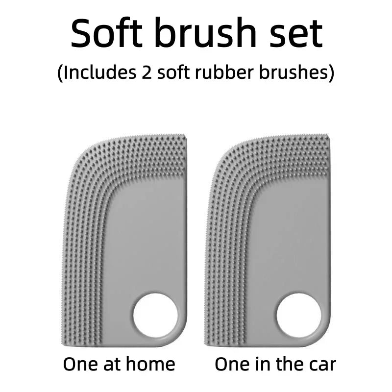 A set of two grey, arched soft rubber detail brushes with textured edges and a circular finger hole.