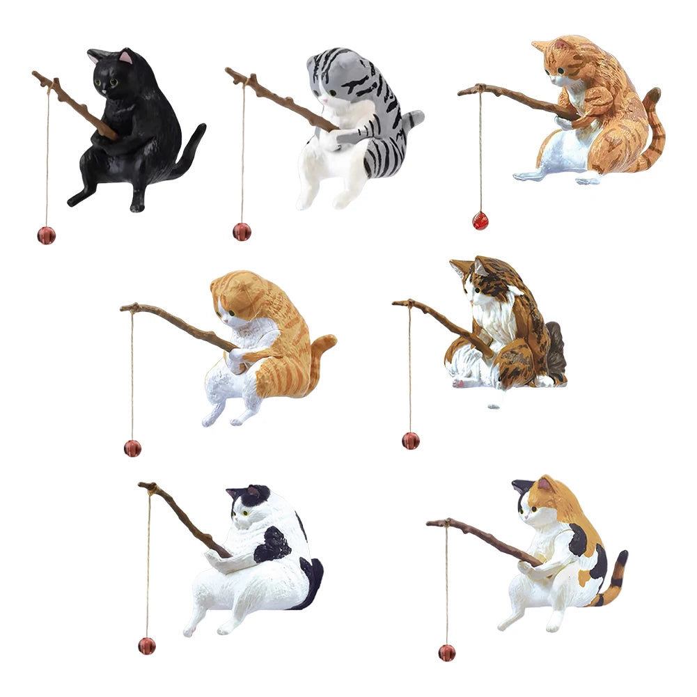 A collection of seven small, colourful cat figurines, each holding a wooden fishing rod with a hanging bead.